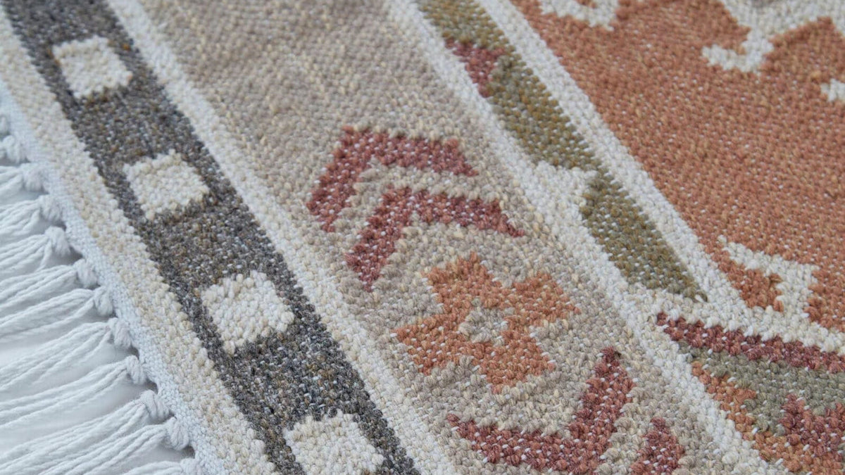 Close-up weave of pink, terracotta and sage Weaver Green outdoor rug