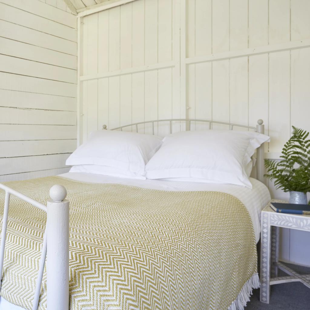 Herringbone Gooseberry Blanket on bed
